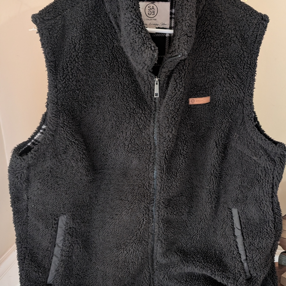 Sage Collective Black Sherpa Vest With Black And White Plaid Inside.